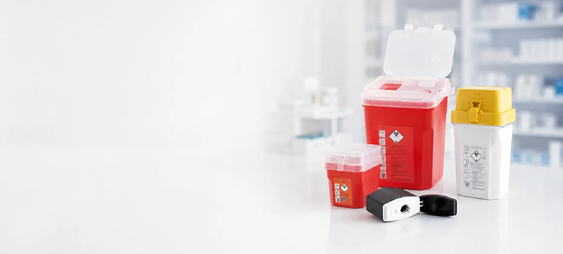 Red, white and yellow sharps containers in multiple sizes with compact disposal cases